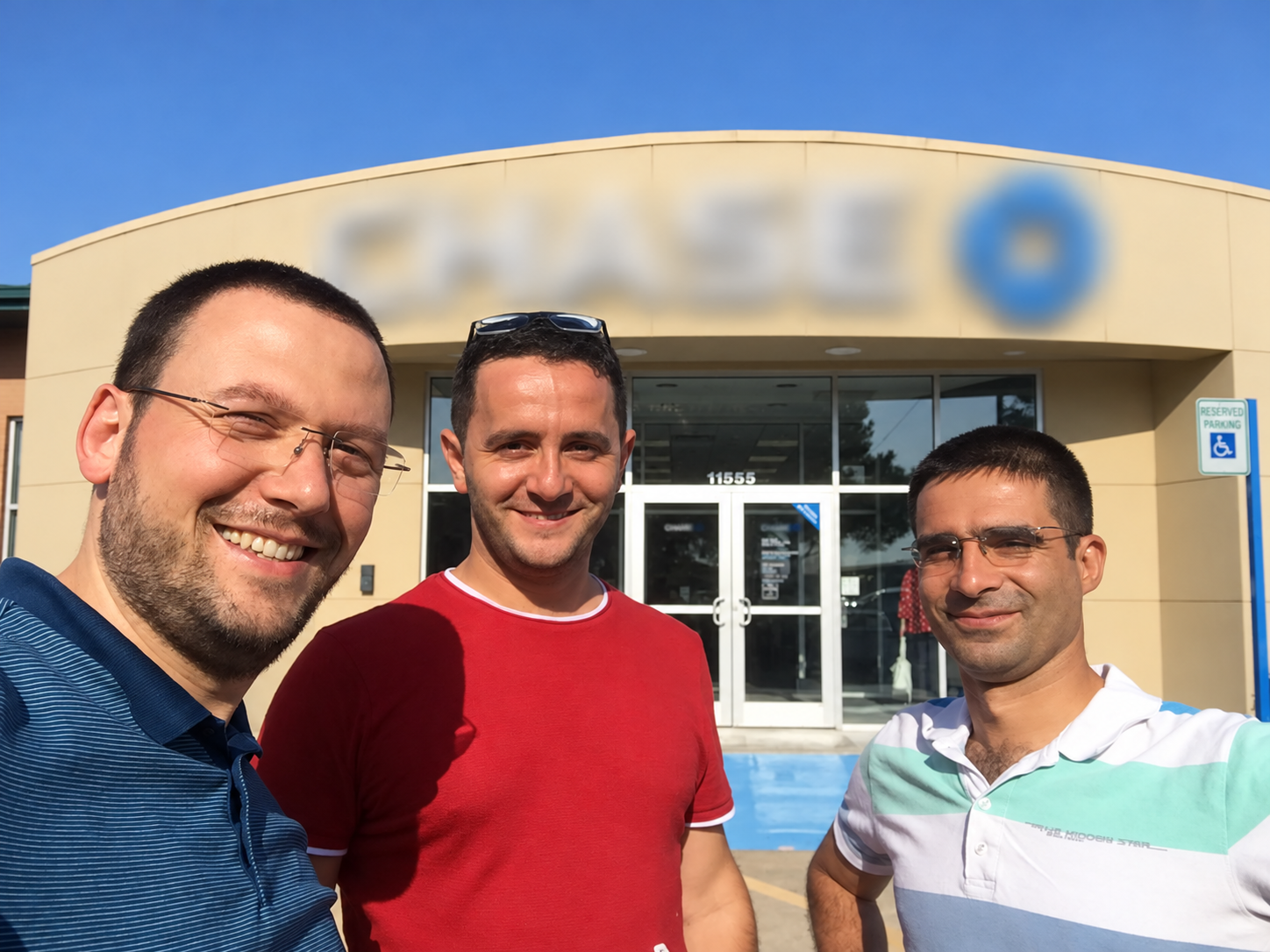 Marine Infotech founders Ali Tunc, Jack Jordan, and Seyit Ozturk smiling outside a Houston bank branch on the day they opened the company's first business account in 2018